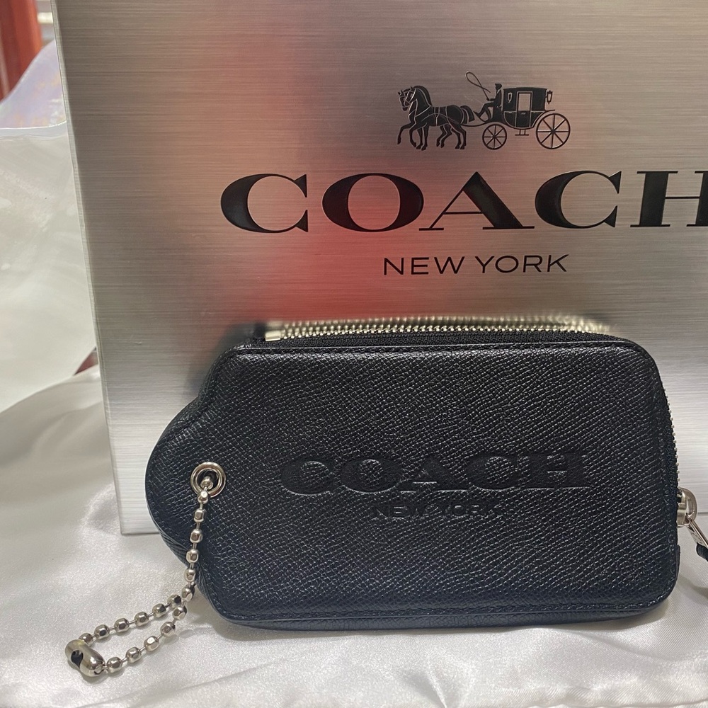 Coach baggage tag with zipper in black and red polka dots.
